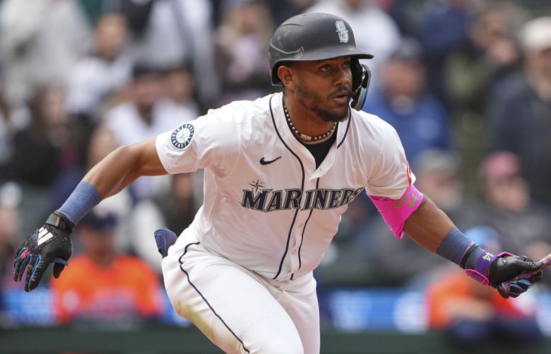 Seattle Mariners’ Julio Rodriguez hits a two-run double to score Donovan Solano and Miles Mastrobuoni against the Houston Astros during the ninth inning of a baseball game Wednesday, April 9, 2025, in Seattle. (AP Photo/Lindsey Wasson) WALW347 WALW347