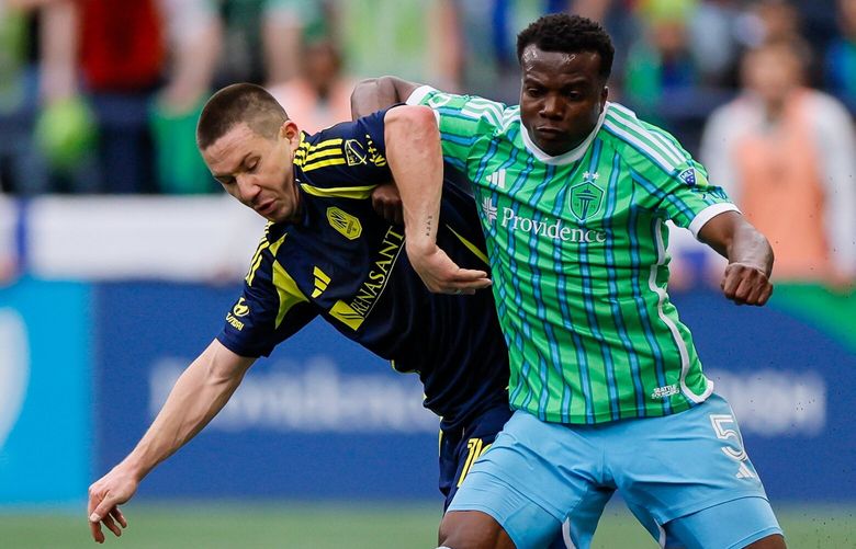 Seattle Sounders FC defender Nouhou pushes off Nashville SC midfielder Alex Muyl during the first half Saturday, April 19, 2025 in Seattle. 229791