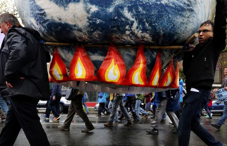 Representing global warming, a giant globe is carried the entire parade route from Cal Anderson Park to Seattle Center during the Earth Day March for Science where several thousand participated Saturday.

Here, they head north on Fourth Avenue.


Saturday April 22, 2017