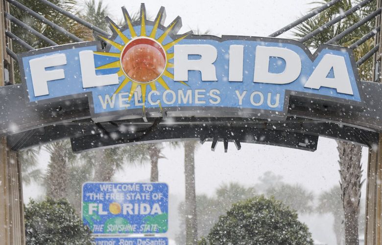 FILE – Heavy snow falls onto the Florida Welcome Center on Jan. 21, 2025 in Pensacola, Fla. (Luis Santana /Tampa Bay Times via AP, File) FLPET201 FLPET201