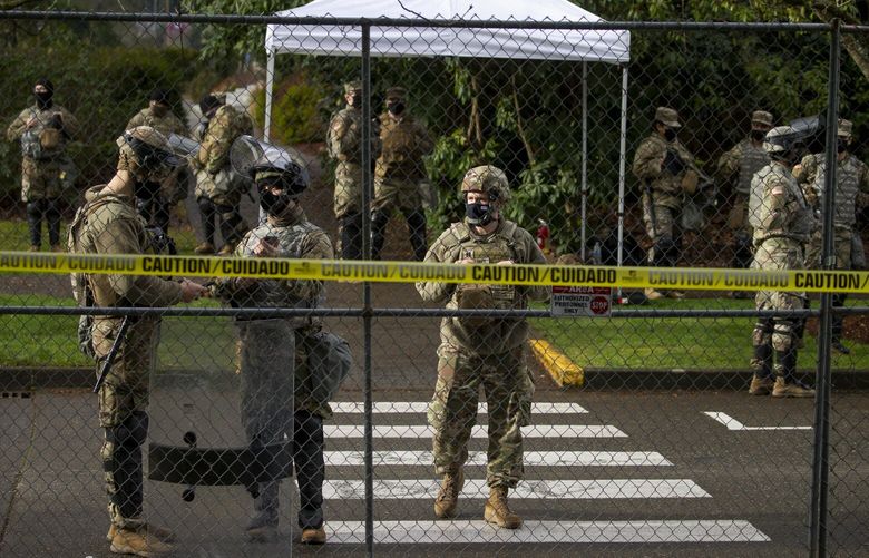 Washington National Guard members stand at the barricade around the Washington State Capitol building Sunday January 17, 2021, a day that many expected to see political protests ahead of the inauguration of Joe Biden as president. 216151