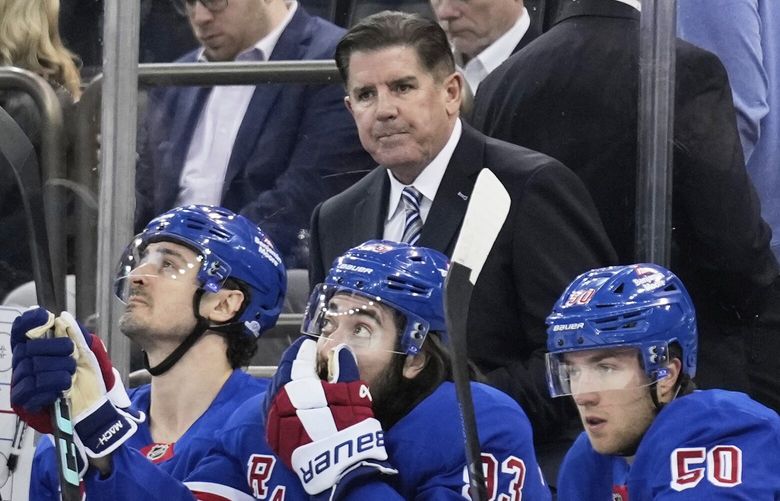 New York Rangers coach Peter Laviolette, top, watches during the first period of an NHL hockey game against the Tampa Bay Lightning in New York, Thursday, April 17, 2025. (AP Photo/Seth Wenig) NYSW106 NYSW106