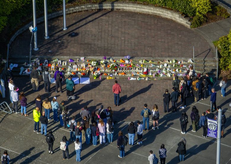 Garfield High School students and staff, many who brought flowers to add to a vigil, gather before the start of classes Tuesday to remember Salvador “Junior” Granillo, a senior who was fatally shot in Yakima on Sunday. (Ken Lambert / The Seattle Times)