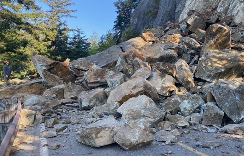 A rockslide blocks State Route 11 (Chuckanut Drive) near milepost 10 in Skagit County Tuesday, April 22, 2025. Troopers on scene are reporting that the boulder pile is greater than 20 feet high.