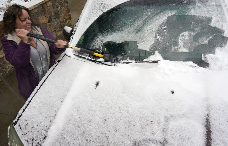Diane Lee cleans the windshield of her sports-utility vehicle as she heads home after a day at her job with the Clear Creek County Sheriff’s Department while a storm packing high winds and snow sweeps through the intermountain West Tuesday, Sept. 8, 2020, in Georgetown, Colo. Forecasters predict that the storm will continue through Wednesday before moving out on to the plains. (AP Photo/David Zalubowski) CODZ104
