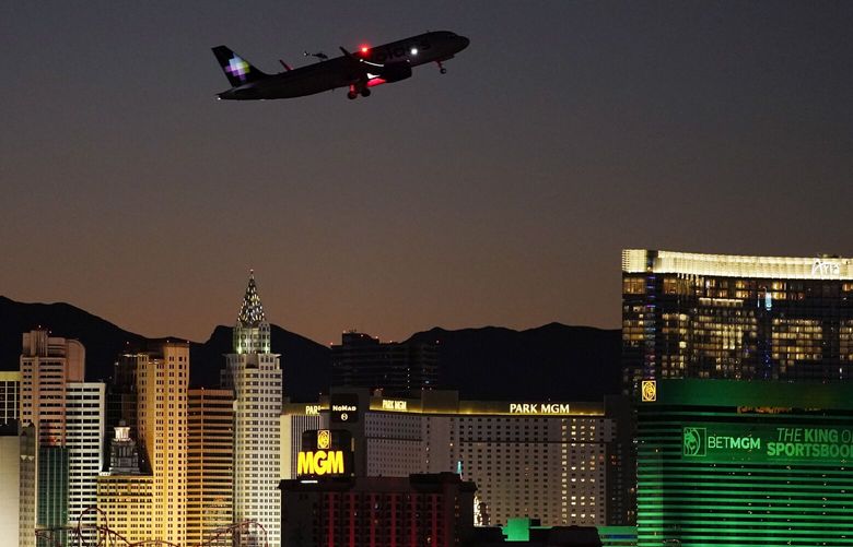 FILE – A plane takes off from Harry Reid International Airport near casinos along the Las Vegas Strip, Sept. 29, 2021, in Las Vegas. The year 2022 was good for gambling and tourism in Nevada. New data posted Tuesday, Jan. 31, 2023, showed house winnings at casinos statewide set calendar year records and visitor tallies in Las Vegas nearly reached levels seen before the coronavirus pandemic. (AP Photo/John Locher, File)
