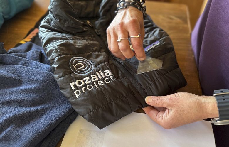 Rachael Z. Miller, founder of the Vermont-based Rozalia Project for a Clean Ocean, conducts a tape test on various clothing items to compare how much each material sheds microfibers on Thursday, April 17, 2025, in Granville, Vt. (AP Photo/Amanda Swinhart) CLI503 CLI503
