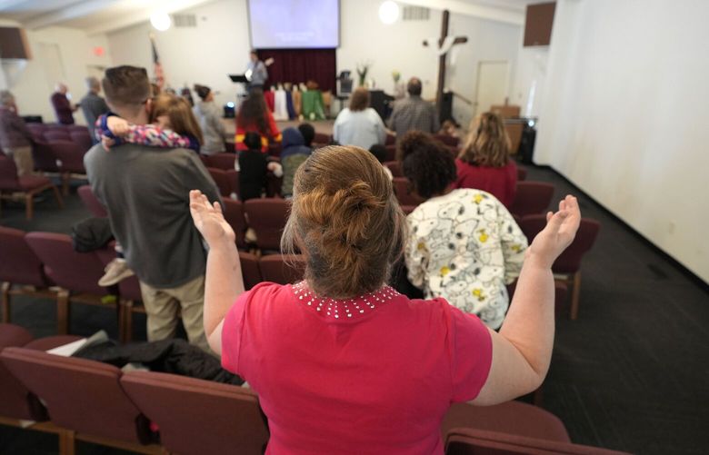 FILE – People pray during a service at the First Church of God, Jan. 7, 2024, in Des Moines, Iowa.  (AP Photo/Charlie Neibergall, File) NY116 NY116