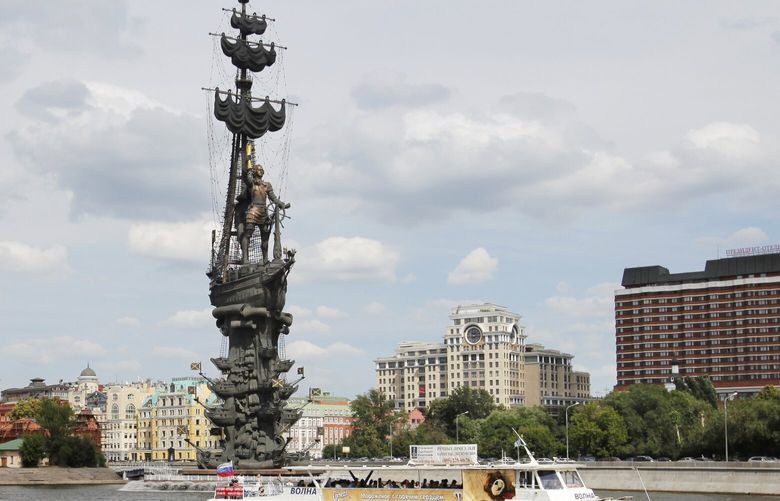 FILE – A boat floats past a huge monument to Peter the Great, created by Georgian and Russian sculptor Zurab Tsereteli, on the Moscow River in Moscow, on June 26, 2012.(AP Photo/Alexander Zemlianichenko, File) XPAG214 XPAG214