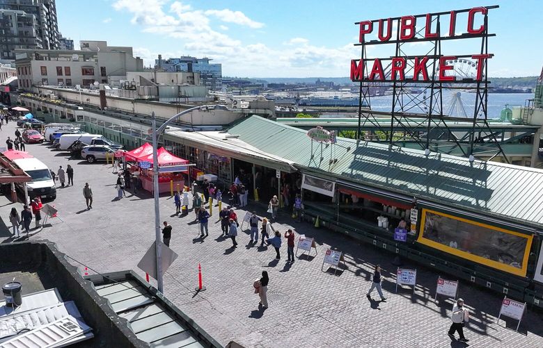 Pedestrians enjoy a relatively car free street due to a construction project at Pike Place Market on Tuesday, April 22, 2025. Starting on April 23rd the change will block most traffic except for emergency vehicles, deliveries and people with disabled parking permits. A paving construction project is also happening at Stewart St and Pike Place.