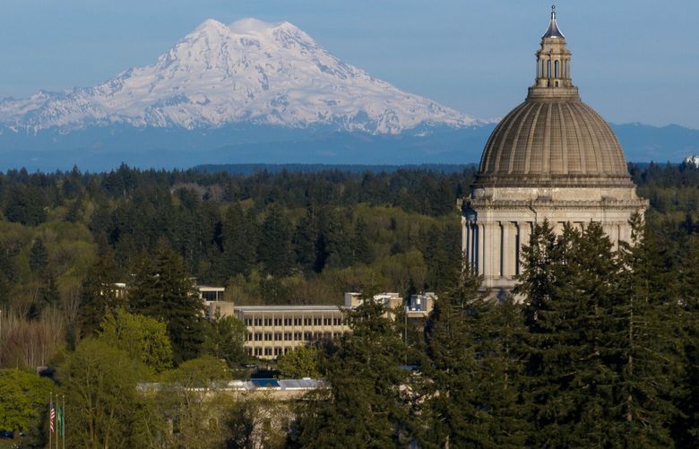 Mount Rainier looms large behind the Washington State Capitol building on Thursday, April 17, 2025, in Olympia.