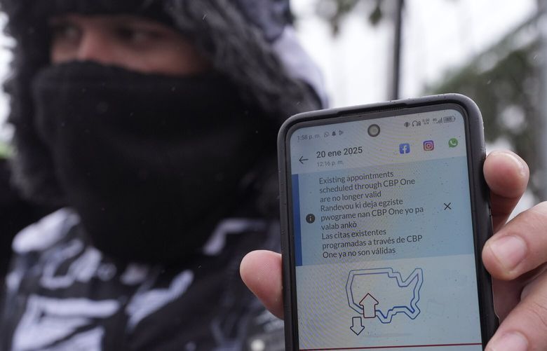 FILE – A migrant seeking asylum holds up the CBP One app showing his appointment was canceled after President Donald Trump was sworn into office, Jan. 20, 2025, in Matamoros, Mexico. (AP Photo/Eric Gay, File) NYWS301 NYWS301
