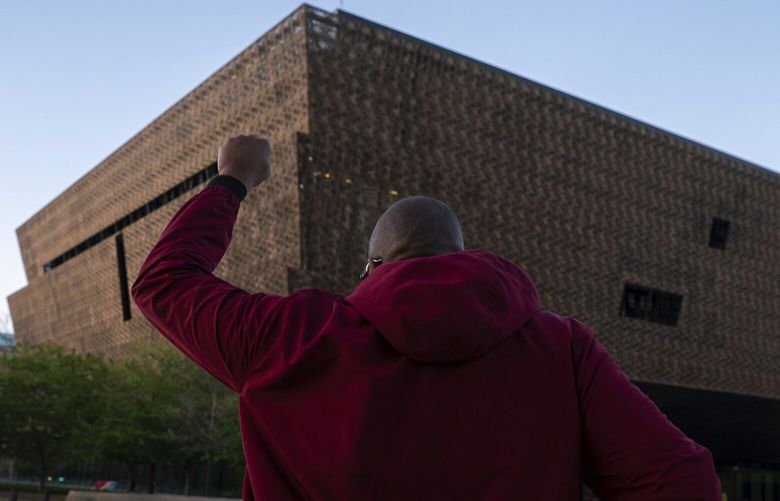 Pastor Robert Turner walks past the National Museum of African American History and Culture as part of his monthly walk from Baltimore to Washington to raise awareness of reparations on Wednesday, April 16, 2025, in Washington. (AP Photo/Nathan Howard) DCNH201 DCNH201