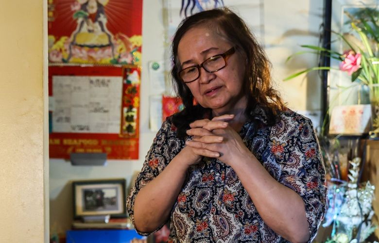 Loan Duong, mother of Hien Trung Hua, stands over a shrine in his memory in Yakima, Washington, on June 18, 2024. Hien Trung Hua died in the Yakima County Jail in November 2023. 227144
