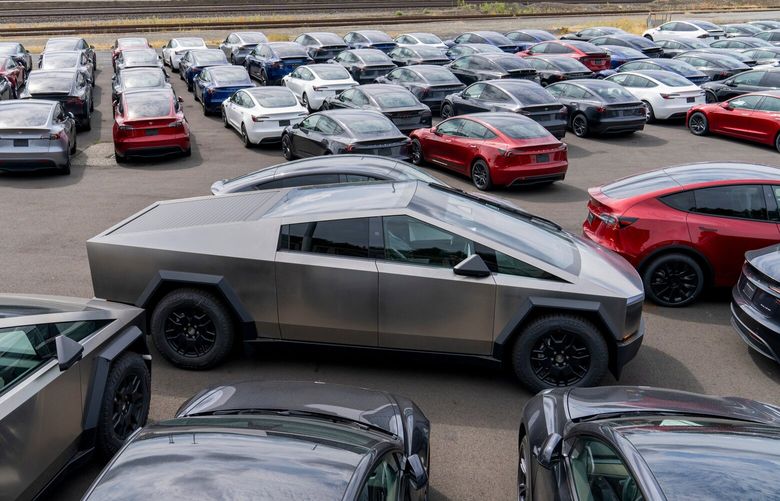 A new Tesla Cybertruck, center, and other Tesla vehicles parked at a logistics drop zone in Seattle, Washington, US, on Thursday, Aug. 22, 2024. The worlds largest seller of battery-electric vehicles is well off its pace of 1.8 million deliveries last year and reiterated that volume growth will be notably lower in 2024. Photographer: M. Scott Brauer/Bloomberg
