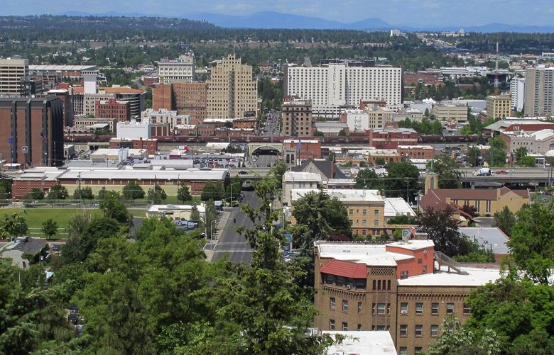 FILE – The downtown skyline is shown from the South Hill in Spokane, Wash., on June 4, 2018. The American Civil Liberties Union of Washington has sued the city of Spokane, alleging that its anti-homeless laws violate the state constitution. The group filed the suit on Thursday, Aug. 1, 2024, on behalf of a currently homeless person and someone who was formerly homeless. (AP Photo/Nicholas K. Geranios, File)