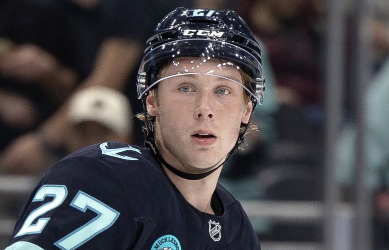 Seattle Kraken center Berkly Catton (27) readies for a face-off during an NHL preseason hockey game against the Calgary Flames on Sunday, Sept. 22, 2024, in Seattle.