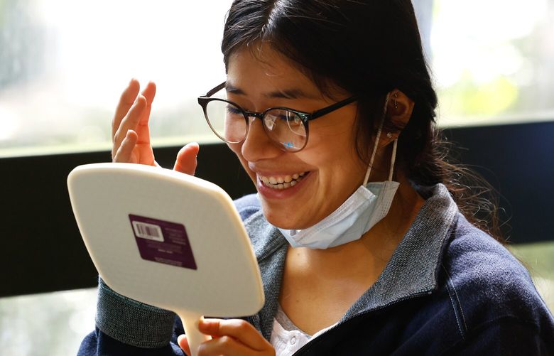 “They’re super cute!” says Jocelin Anahipavilla Moreles as she tries on a pair of new glasses picked out by optician Jennifer Felix Gray (not in photo) “She picked out the perfect one.” at the Seattle/King County Clinic’s free health clinic at the Seattle Center on Thursday, April 24, 2025. The glasses are hers for free. The clinic runs from Thursday through Sunday April 27th on a first come, first basis starting at 5:30am each day. The clinic serves people who are struggling to make ends meet – the clinic tries to remove barriers to health care of any kind. They offer interpretation services, patients do not need to show documentation of any kind and can be from anywhere, not just Seattle or King County. Dental, vision and medical services are offered. Each year it takes approximately 3,000 clinical and non-clinical volunteers to produce the clinic.