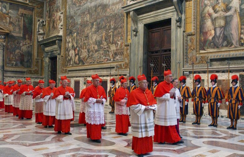 FILE – Cardinals walk in procession to the Sistine Chapel at the Vatican, at the beginning of the conclave, April 18, 2005. (Osservatore Romano via AP, File) XBL506 XBL506