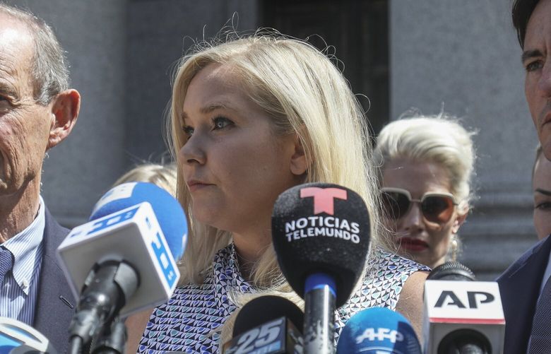 FILE – Virginia Giuffre, center, holds a news conference outside a Manhattan court in New York, Aug. 27, 2019. (AP Photo/Bebeto Matthews, File) NYAB503 NYAB503