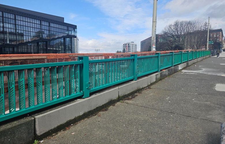 The new custom railings installed on the bridges over Interstate-5 on Pike and Pine streets in April. Artists Derek Bruno and Gage Hamilton designed panels that feature wave and mountain forms that are represented throughout the project.