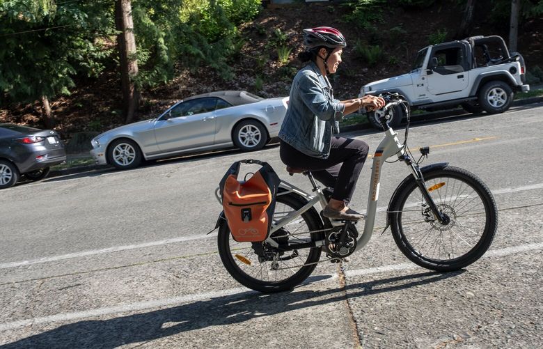 Nicole Tsong climbs a hill from Seward Park.  

Nicole Tsong tries commuting on an E-Bike, along Lake Washington and Seward Park.  

Photographed May 24, 2018. 206397