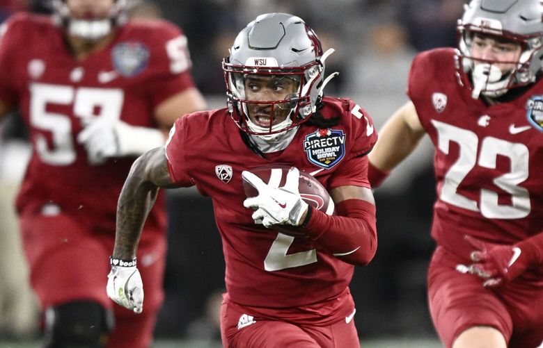 Washington State wide receiver Kyle Williams (2) breaks away from Syracuse defensive back Alijah Clark (5) as he scores on a touchdown reception during the first half of the Holiday Bowl NCAA college football game Friday, Dec. 27, 2024, in San Diego. (AP Photo/Denis Poroy)
