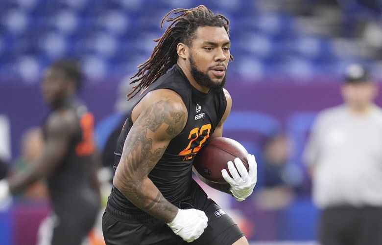 Miami running back Damien Martinez runs a drill at the NFL football scouting combine in Indianapolis, Saturday, March 1, 2025. (AP Photo/Michael Conroy)