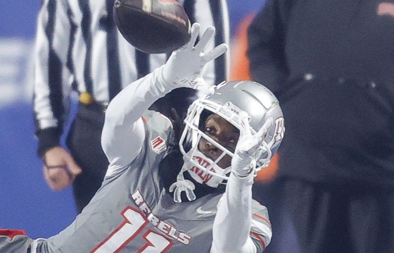 UNLV wide receiver Ricky White III (11) reaches the ball on the sideline against Boise State second half of the Mountain West Championship NCAA college football game Friday, Dec. 6, 2024, in Boise, Idaho. Boise State won 21-7. (AP Photo/Steve Conner)