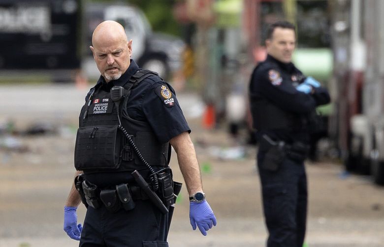 Forensics officers with the Vancouver Police canvas the scene Sunday, April 27, 2025, where a driver killed multiple people the day prior during a Filipino community festival in Vancouver, B.C.