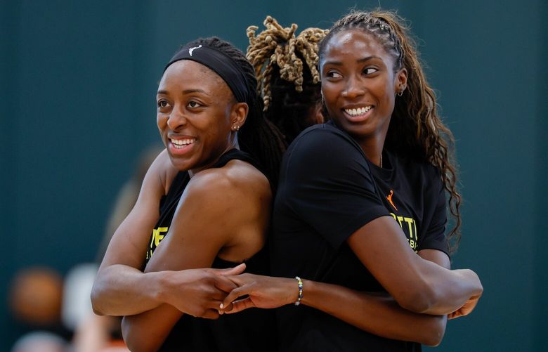 Seattle Storm players Nneka Ogwumike, left, Jordan Horston, center, and Ezi Magbegor join hands after the opening day of training camp Sunday, April 27, 2025 in Seattle. 229808