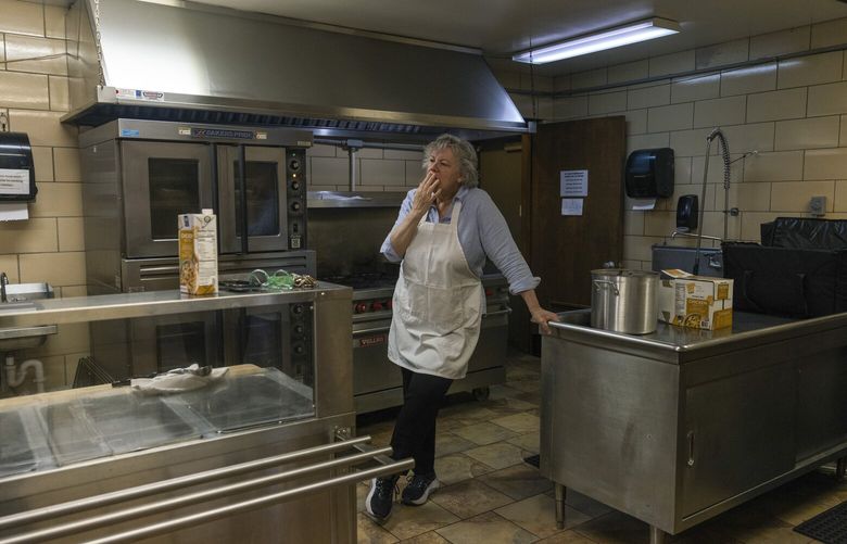 Sara Busse, a volunteer at Trinity’s Table, takes a break from making food in Charleston, W. Va., April 16, 2025. After federal cuts, food banks scrounge and scrimp; in one of the country’s poorest areas, the quantity and quality of government deliveries have dropped, forcing one charity to make do with thin soup and dried cranberries. (Maddie McGarvey/The New York Times)
