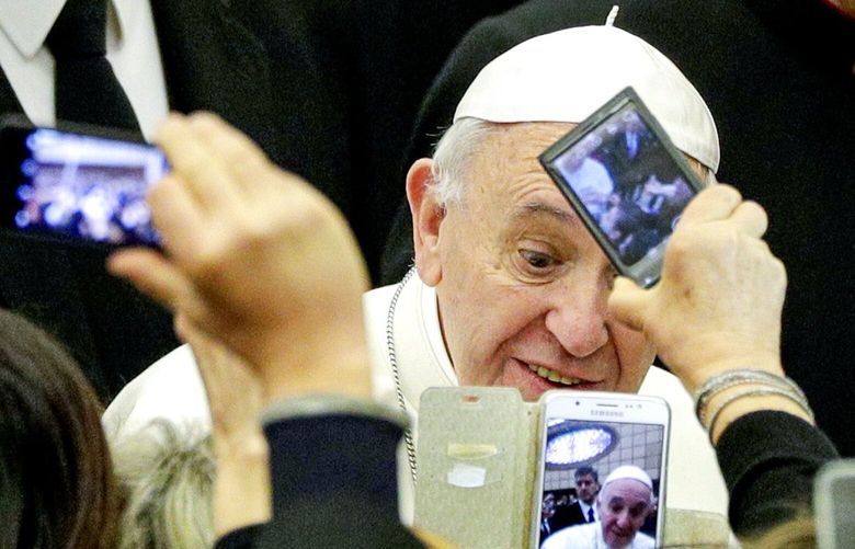 People take pictures of Pope Francis upon his arrival at the Vatican, Feb. 15, 2017. GB105