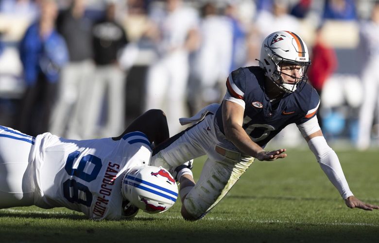 Virginia quarterback Anthony Colandrea (10) is sacked by SMU defensive tackle Mike Yoan Sandjo-Njiki (98) during the second half of an NCAA college football game, Saturday, Nov. 23, 2024, in Charlottesville, Va. (AP Photo/Mike Kropf)