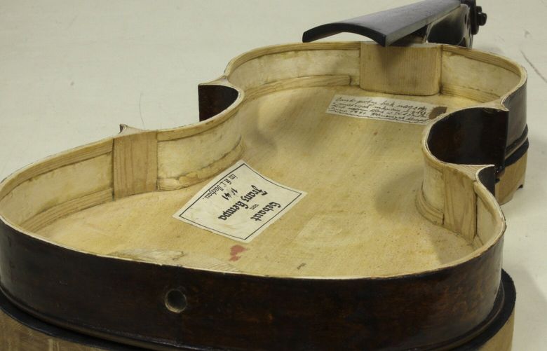 Tags from its maker are seen inside a Dachau-built instrument dubbed the ”violin of hope”, in Magyarpolány, Hungary, Tuesday September 8, 2020. (Szandra Katona via AP) DAC103 DAC103
