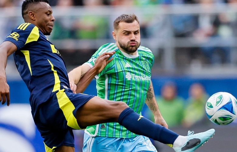 Nashville SC defender Jeisson Palacios clears the ball away from a charging Seattle Sounders FC forward Jordan Morris during the second half Saturday, April 19, 2025 in Seattle. 229791