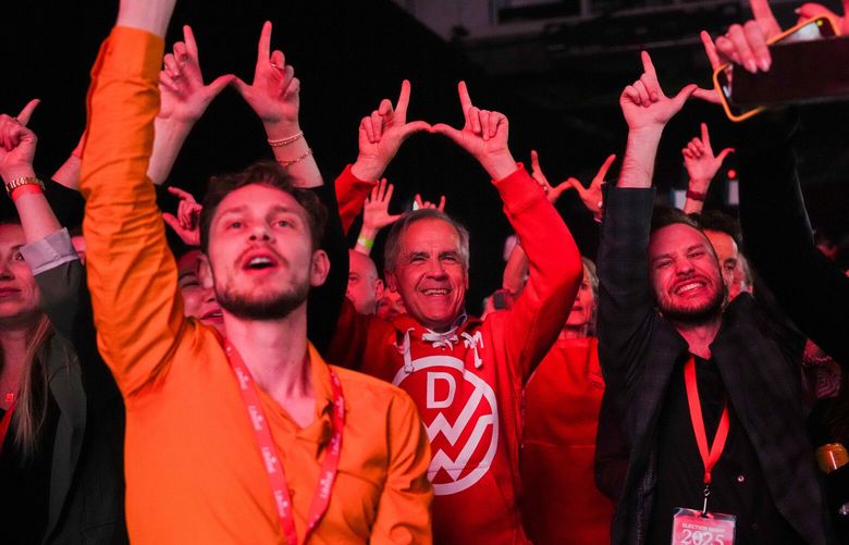 Canadian Prime Minister Mark Carney,center, dances to Canadian band Down With Webster as they play live at campaign headquarters after the Liberal Party won the Canadian election in Ottawa on Tuesday, April 29, 2025. (Sean Kilpatrick/The Canadian Press via AP) SKP160 SKP160
