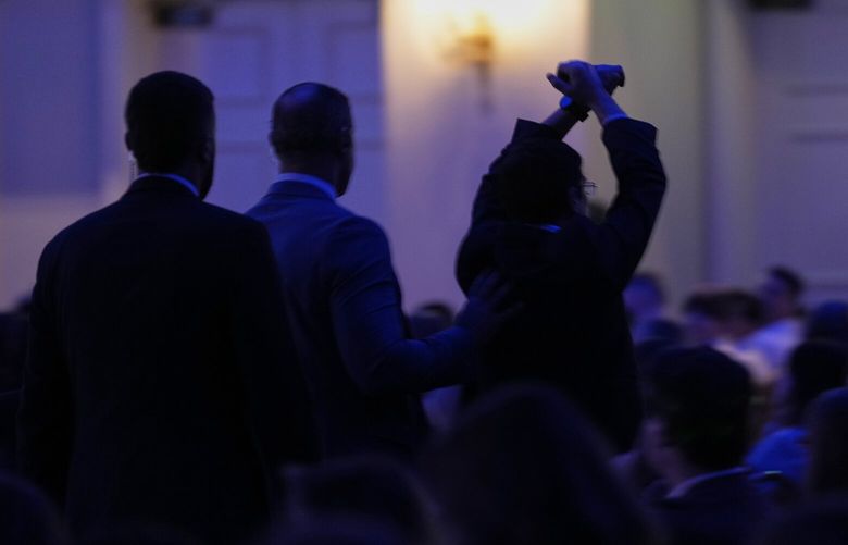 A protester, right, is escorted out of the room as Health and Human Services Secretary Robert F. Kennedy Jr. speaks at the Rx and Illicit drug Summit, Thursday, April 24, 2025, in Nashville, Tenn. (AP Photo/George Walker IV) TNGW408 TNGW408