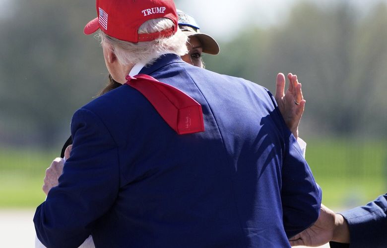President Donald Trump greets Michigan Gov. Gretchen Whitmer as he arrives on Air Force One at Selfridge Air National Guard Base, Tuesday, April 29, 2025, in Harrison Township, Mich. (AP Photo/Alex Brandon) MIJE323 MIJE323
