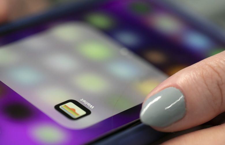 FILE – A person uses an iPhone on Oct. 8, 2019 in New York. Apple is letting some iPhone users fix their own phones, a sharp turnaround for a company that has long guarded its software in a walled garden that only Apple-approved technicians can unlock. The company said Wednesday, Nov. 27, 2021,  it will enable users of two of the newest iPhone models and later some Mac computers to get access to genuine Apple parts and tools to be able to repair them.  (AP Photo/Jenny Kane, File)