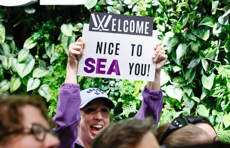 A fan holds up a sign during a press conference announcing the newest PWHL team at Climate Pledge Arena Wednesday, April 30, 2025 in Seattle. 229923