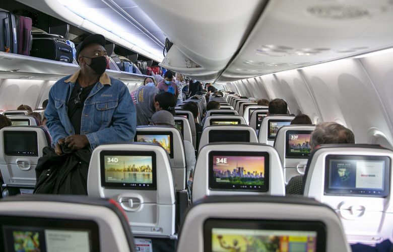 People board a Boeing 737 MAX plane operated by Air Canada at Edmonton International Airport in Alberta, Canada, on Wednesday, July 27, 2022. (AP Photo/Ted Shaffrey)