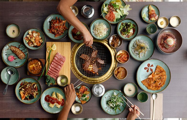 A spread of dishes at a Korean BBQ restaurant.