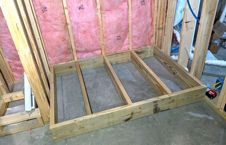 This treated lumber platform will allow a new shower to drain by gravity instead of using a sewage pump. (Tim Carter/Tribune Content Agency)