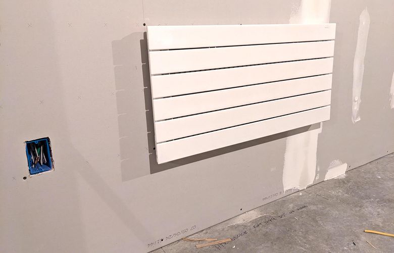 Hidden behind this 50-pound wall heater are flat 2-by-4s nailed between the vertical wall studs. These critical framing members are called blocking, and they ensure the heater never falls to the floor. (Tim Carter/TNS)