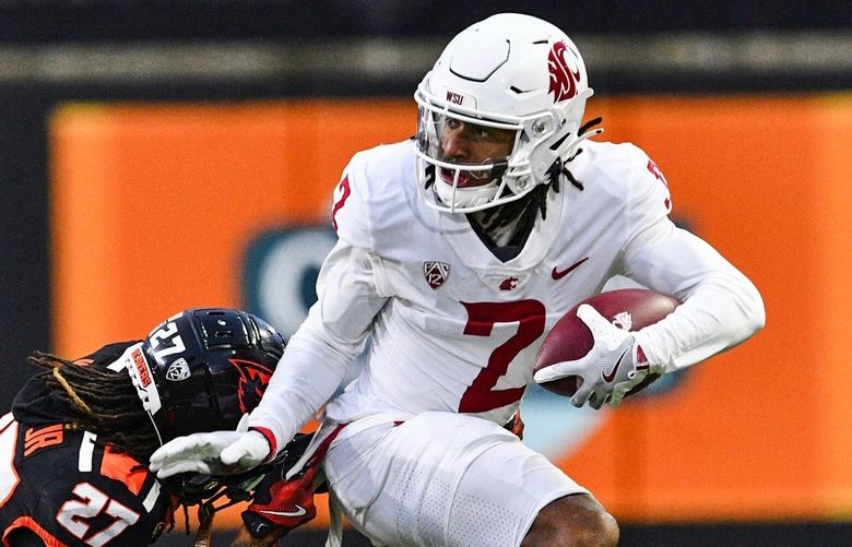 Oregon State defensive back Andre Jordan Jr. (27) attempts to tackle Washington State wide receiver Kyle Williams (2) during the first half of an NCAA college football game Saturday, Nov. 23, 2024, in Corvallis, Ore. (AP Photo/Mark Ylen) ORMY102 ORMY102 ORMY102