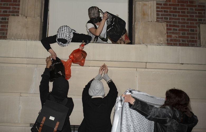 FILE – Protesters against the expulsion of two activists stage a sit-in at Barnard College’s Milbank Hall in New York, Feb. 26, 2025. A top Trump appointee in the Justice Department ordered an aggressive investigation in the last several months of student protesters at Columbia University, raising anger and alarm among career prosecutors and investigators who saw the demand as politically motivated and lacking legal merit, people familiar with the episode said. (C.S. Muncy/The New York Times) XNYT0558 XNYT0558