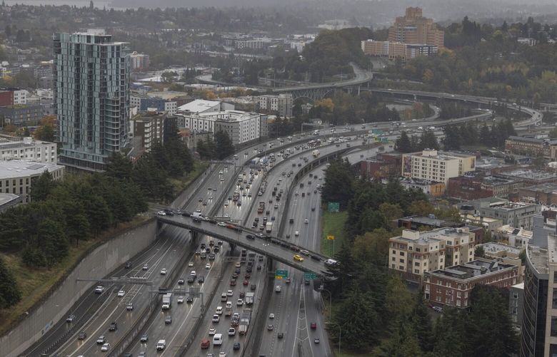 Traffic at left heads northbound on I-5 towards downtown Seattle Friday, October 18, 2024.  The Pacific Medical Center building it at top right. 228306