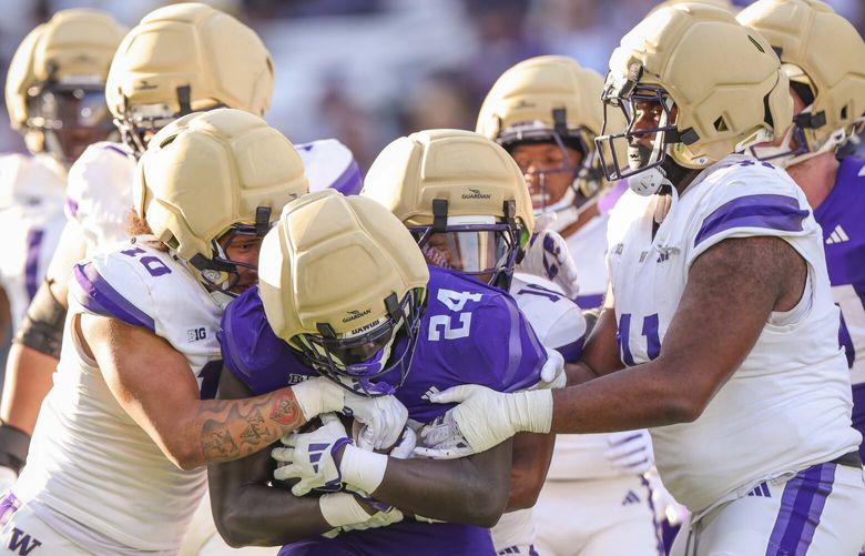 Washington Huskies running back Adam Mohammed (24) gets tackled in the second quarter during a spring scrimmage game at Husky Stadium in Seattle this year, on Friday, May 2, 2025.  229831