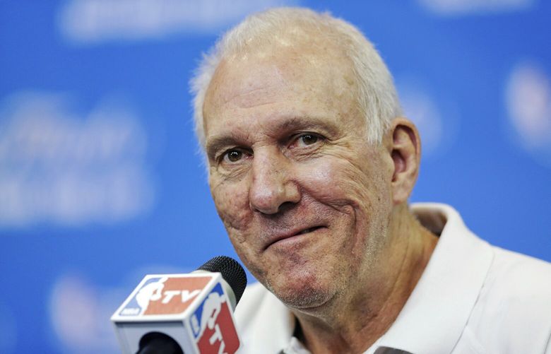 FILE – In this June 14, 2014, file photo, San Antonio Spurs head coach Gregg Popovich smiles as a question is asked during a news conference for the NBA basketball finals in San Antonio. (AP Photo/Tony Gutierrez, File) NYDD210 NYDD210